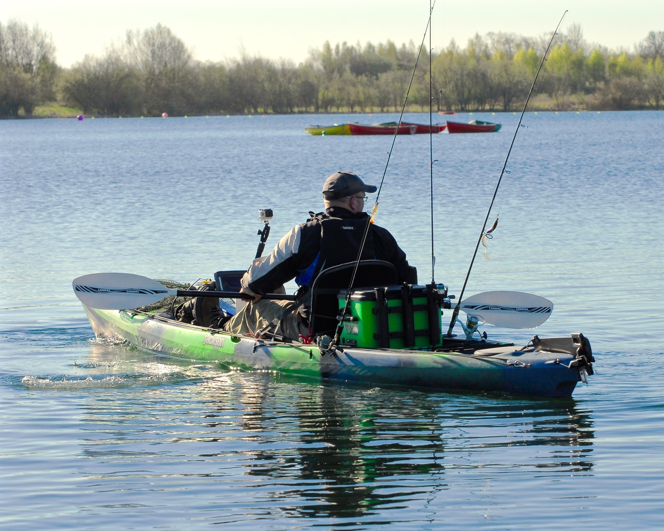 Fishing boat and paddle equipment in natural setting